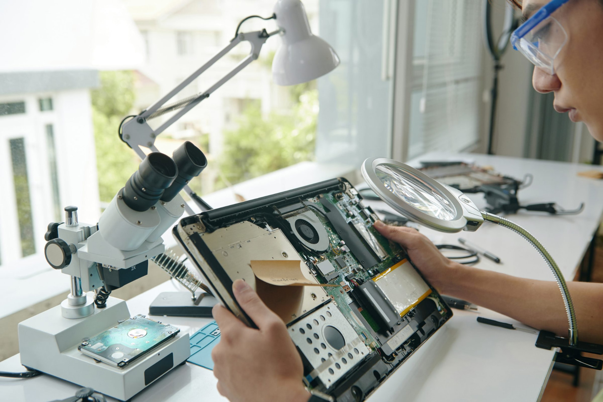 A technician working on a device at the Reconome workbench.