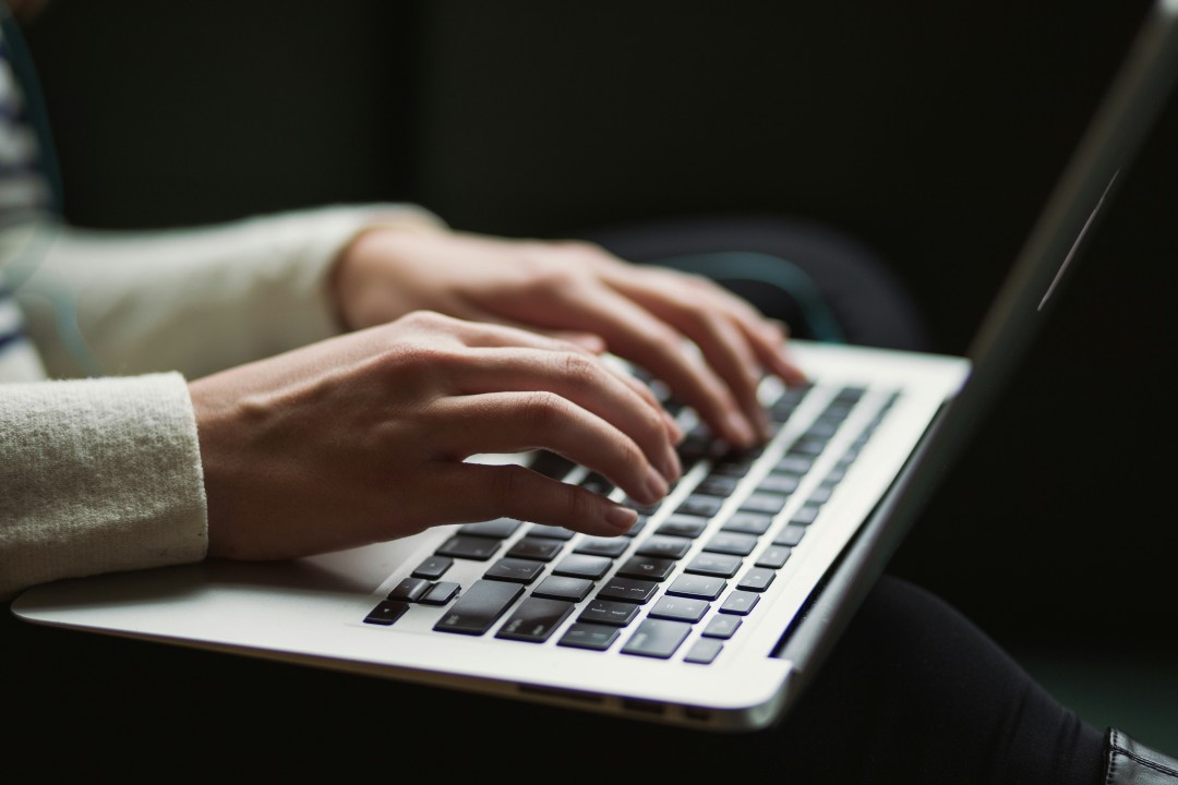 A person using a refurbished laptop.