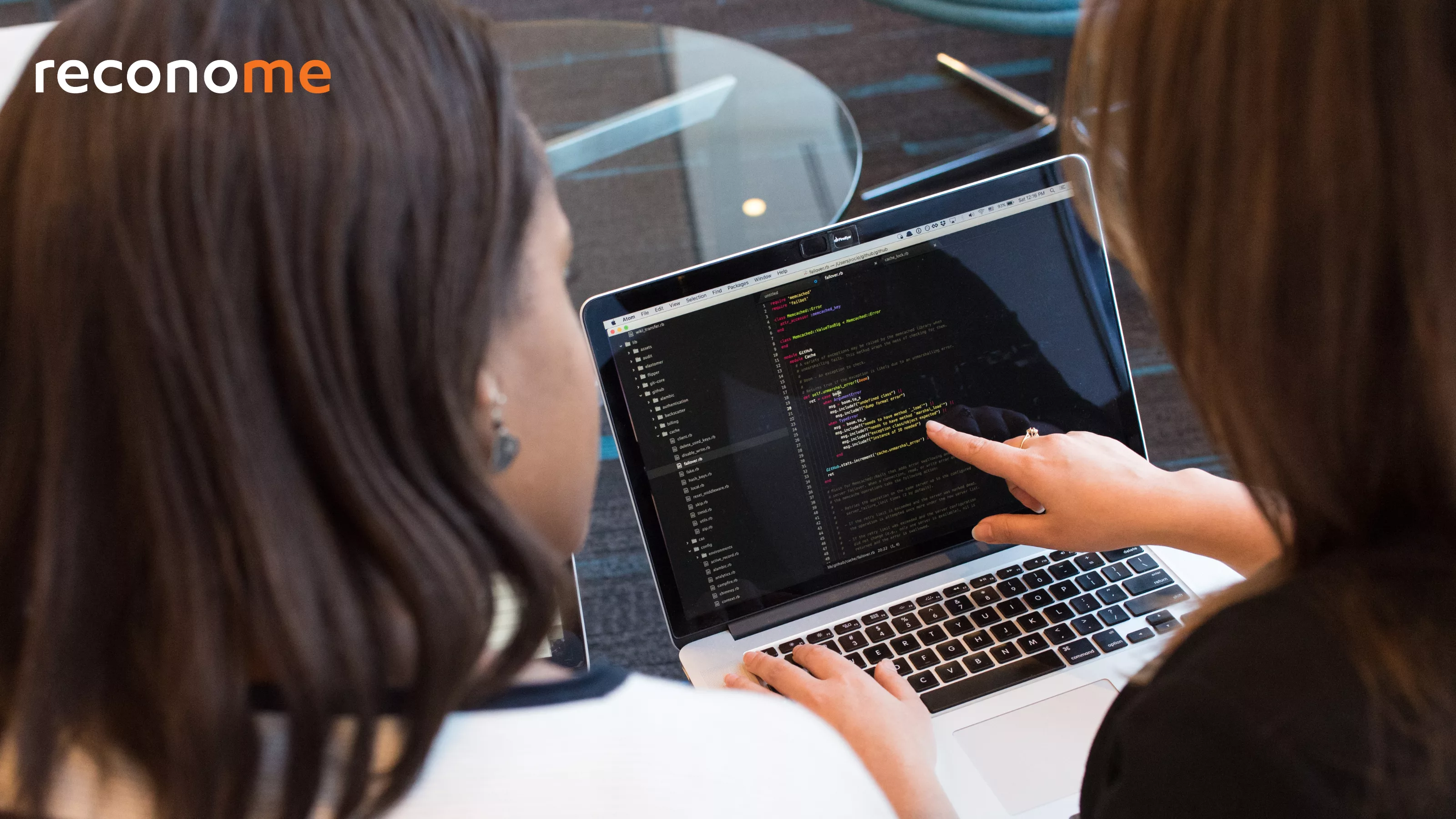 A person pointing at a laptop screen.