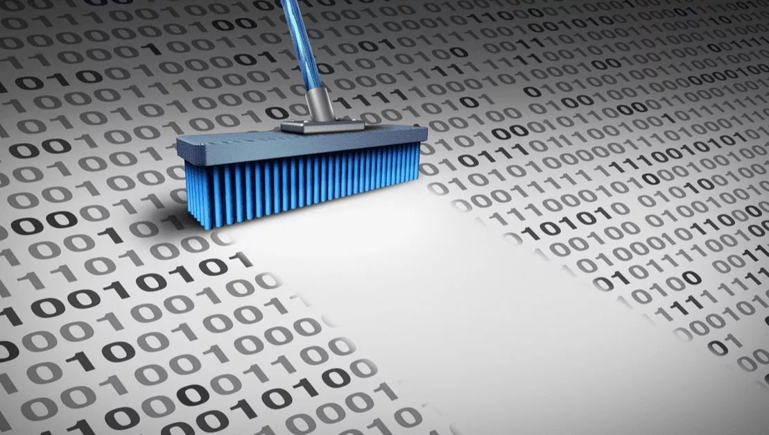 A USB drive lying on a printed binary code sheet.