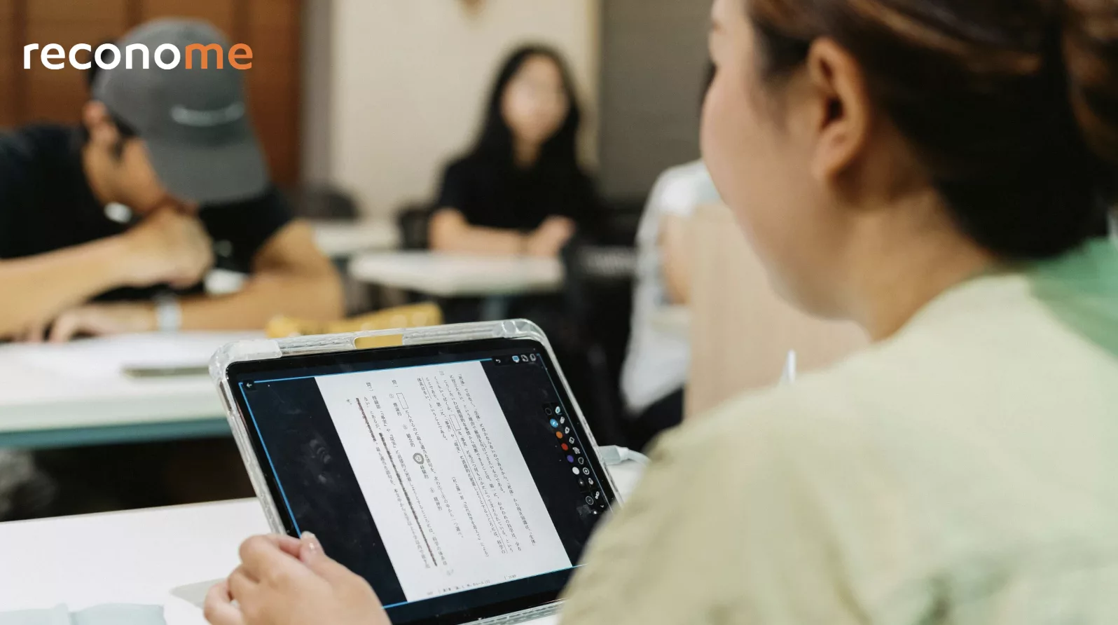 People looking at a laptop during a meeting.