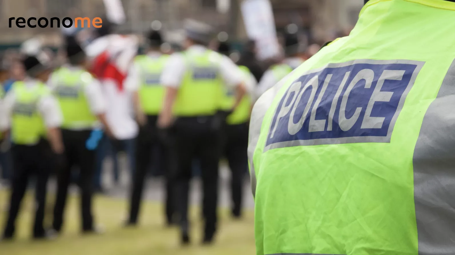 Police officers standing together outdoors.