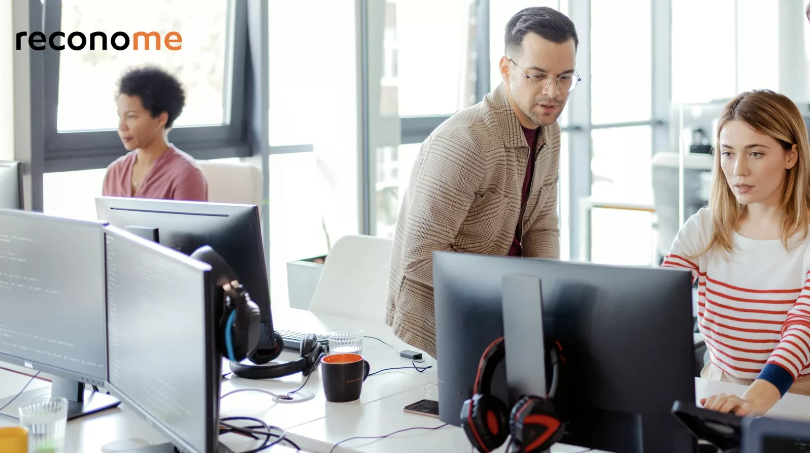People working at desktop computers in an office.