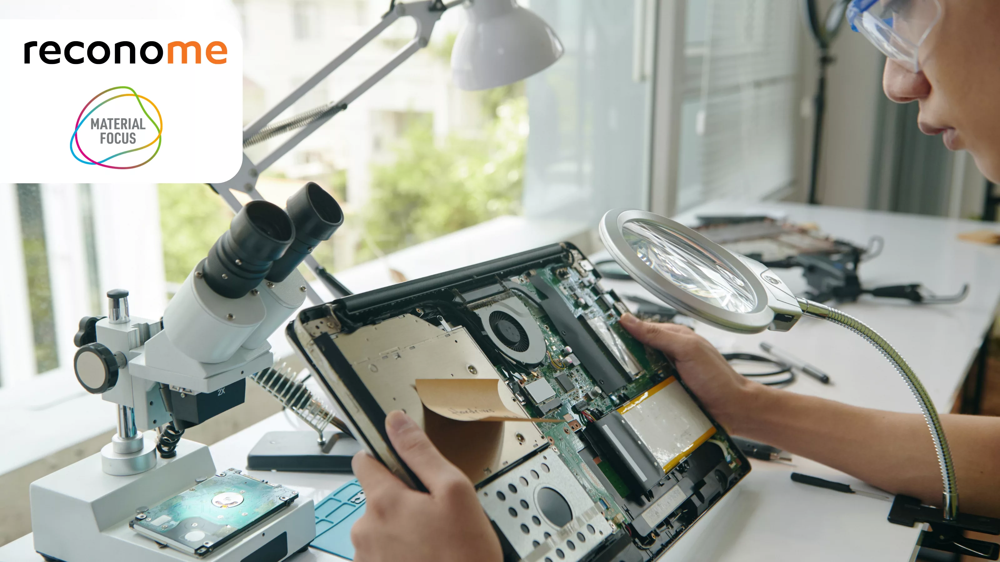 Electronics being repaired under a magnifier.