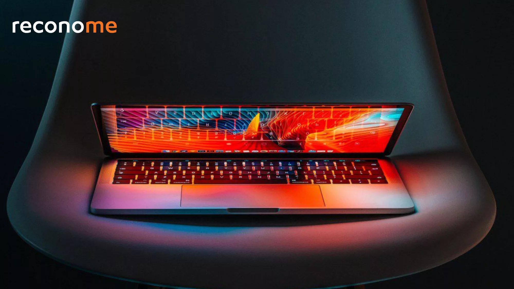 A brightly lit laptop on a dark background.